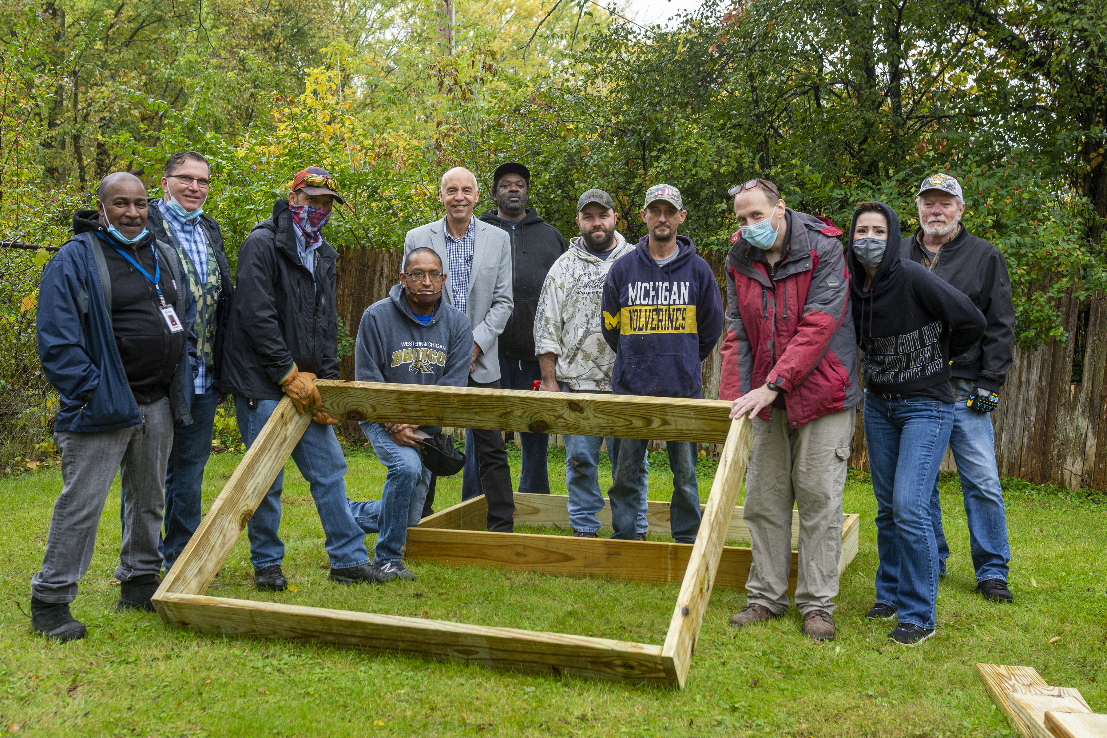 A group of veteran from Keystone house and Lowes posing for a photo while working and make garden beds for Keystone Vets