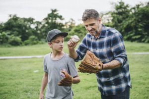 Foster father and son bonding over baseball